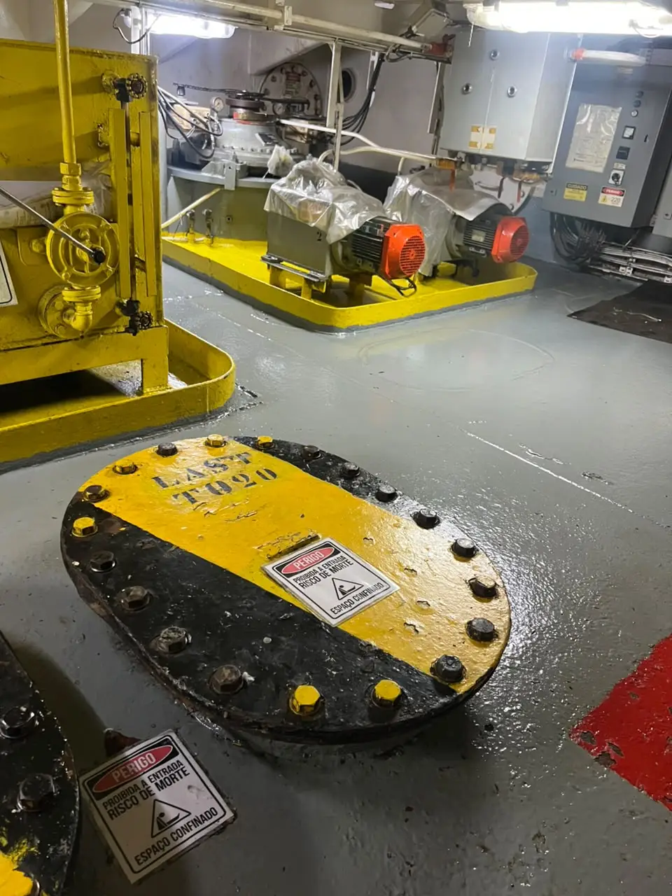 Praça de máquinas de embarcação com tampas de tanque de lastro e equipamento hidráulico