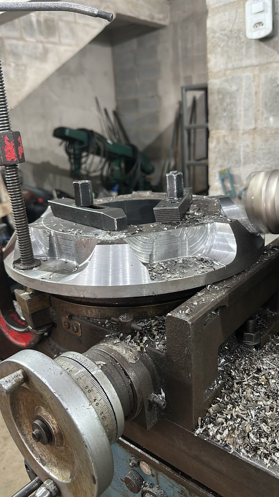 Blank for the new sheave clamped on a rotary table, with the face already rough-machined