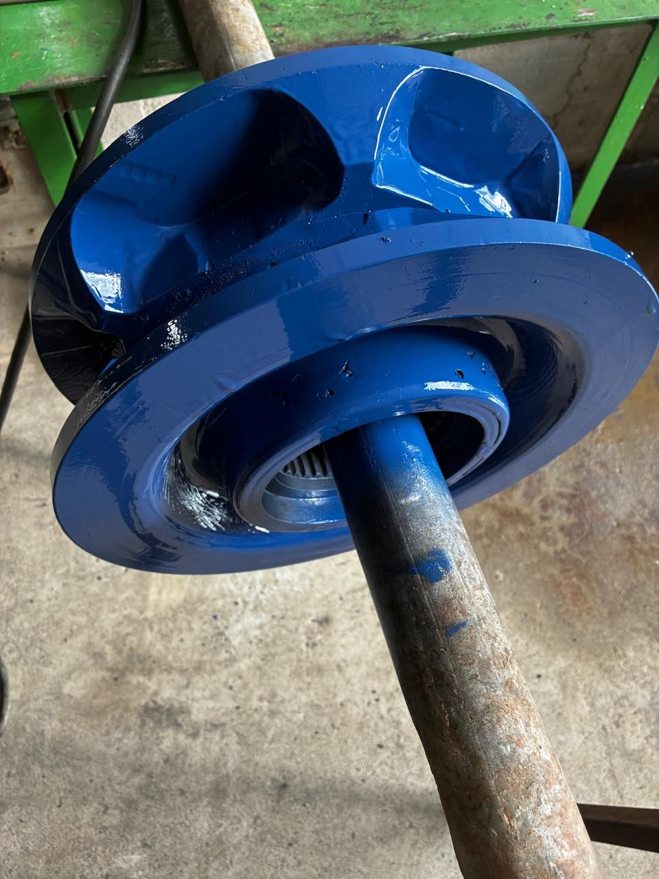 The sheave painted, hung on a bar after application